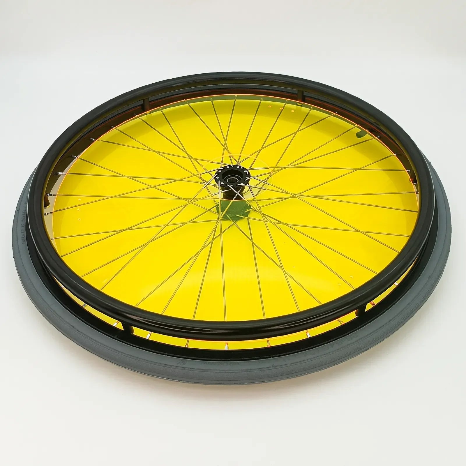 Bright yellow wheelchair wheel with black tire and spoke guards for durability and safety