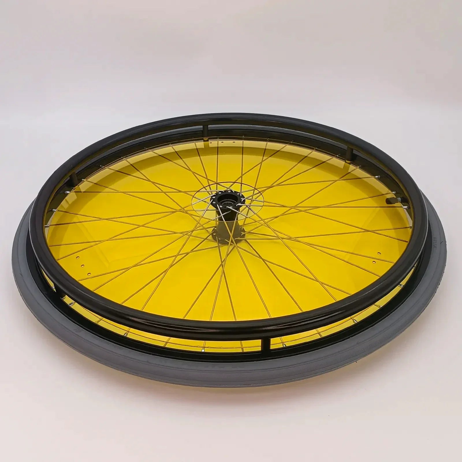 Yellow wheelchair wheel with black spoke guard and tire, durable mobility accessory